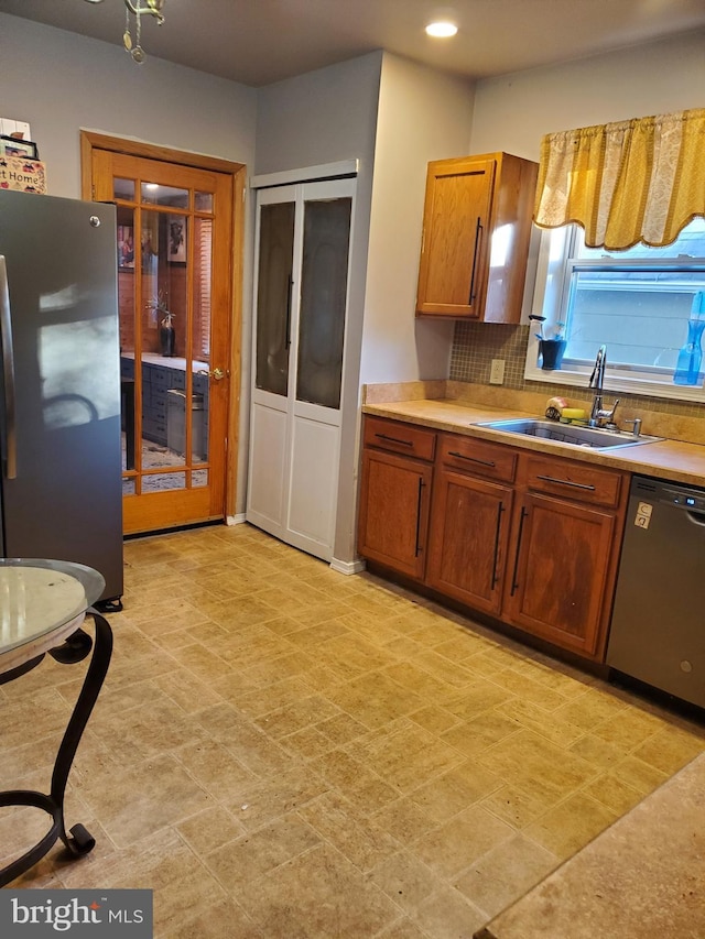 103 Lowden St, Delran, NJ 08075 - kitchen featuring stainless steel appliances, a sink, light countertops, brown cabinets, and backsplash