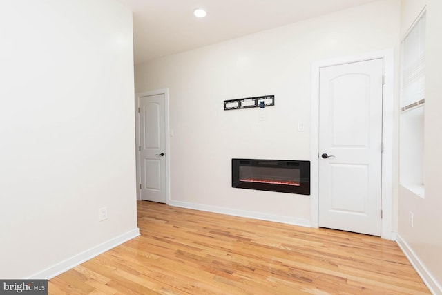 unfurnished living room with light hardwood / wood-style flooring