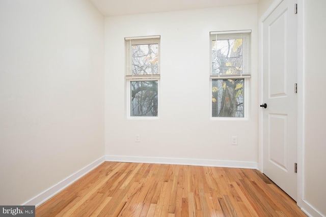 empty room with light wood-type flooring and a healthy amount of sunlight