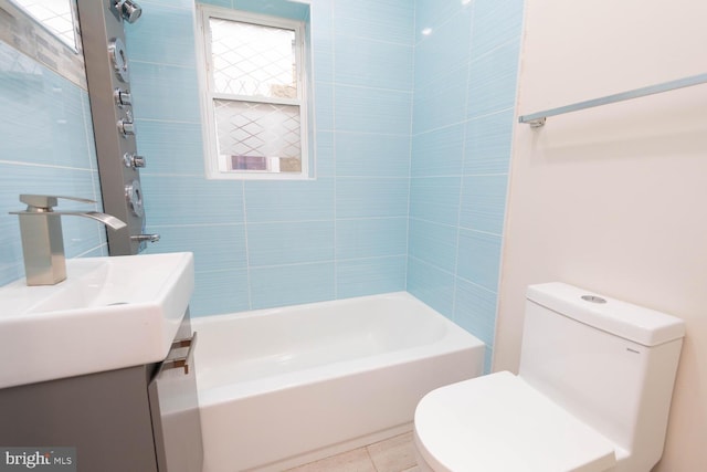 full bathroom with tiled shower / bath, tile patterned flooring, vanity, and toilet