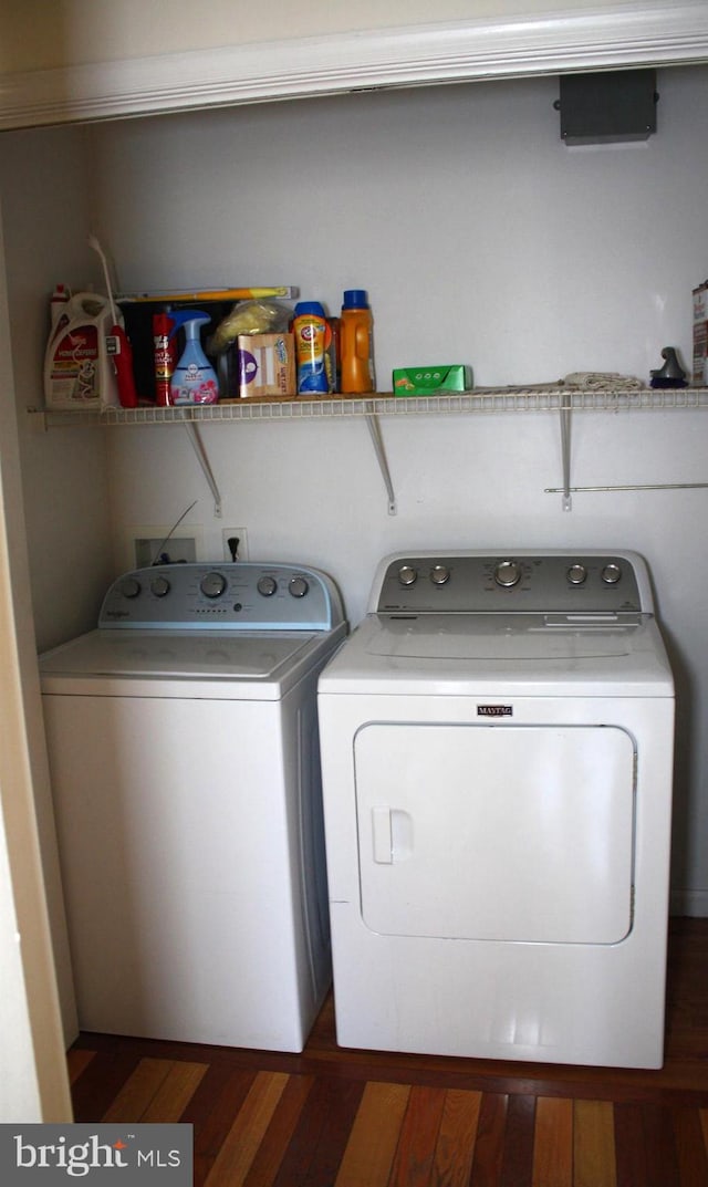 laundry area with independent washer and dryer and dark wood-type flooring