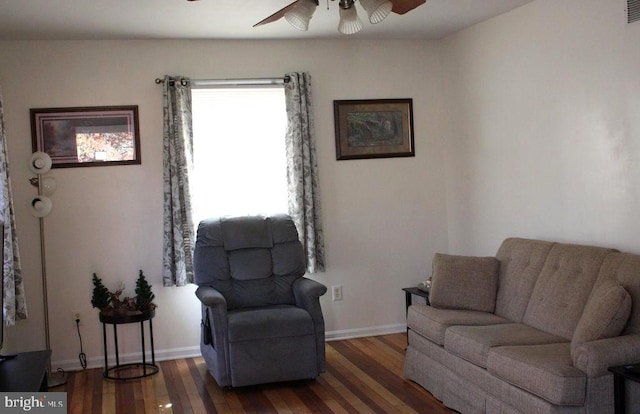 living room with ceiling fan and dark hardwood / wood-style flooring