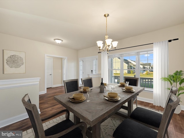 dining room featuring a chandelier and dark hardwood / wood-style flooring