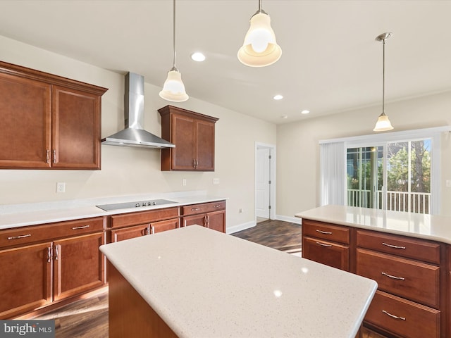 kitchen with black electric stovetop, wall chimney exhaust hood, dark wood-type flooring, and decorative light fixtures