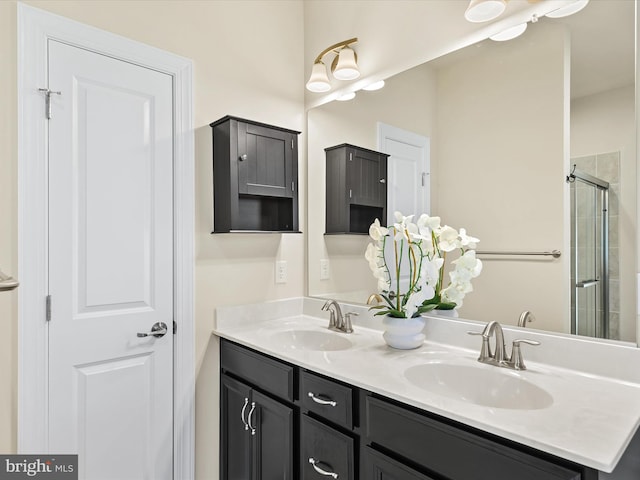 bathroom with a shower with door and vanity