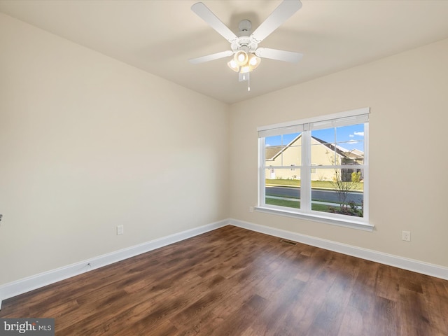 unfurnished room with dark hardwood / wood-style floors and ceiling fan