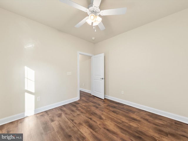 spare room with ceiling fan and dark wood-type flooring