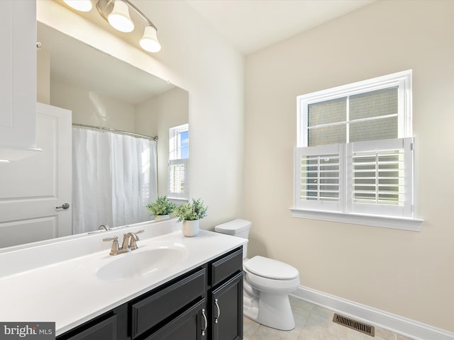 bathroom with tile patterned floors, vanity, and toilet