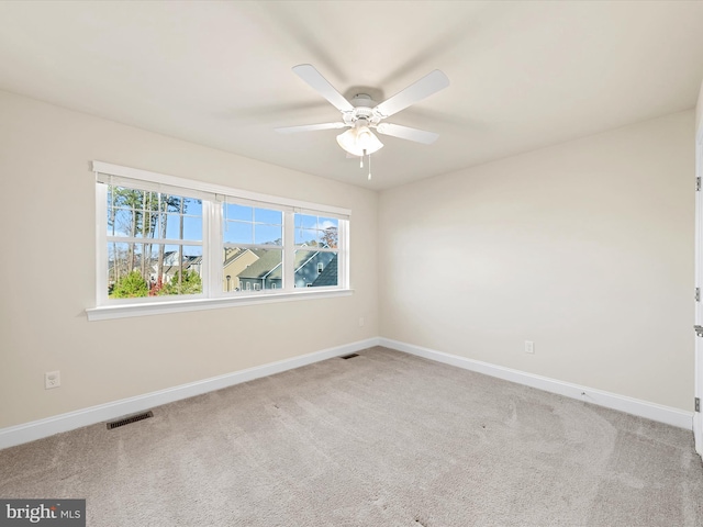 carpeted spare room with ceiling fan and a healthy amount of sunlight