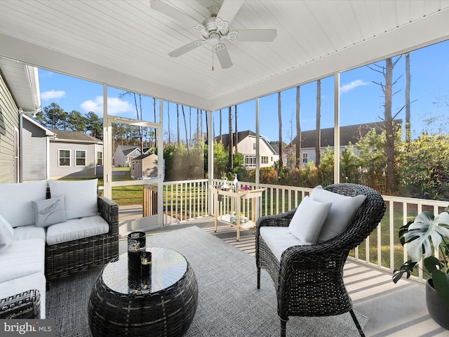 sunroom / solarium with wood ceiling, a wealth of natural light, and ceiling fan