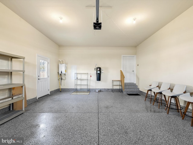 garage with tankless water heater and a garage door opener