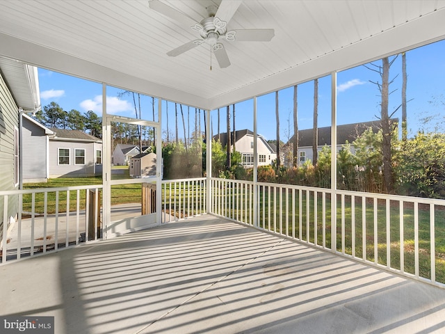 unfurnished sunroom with ceiling fan and wood ceiling