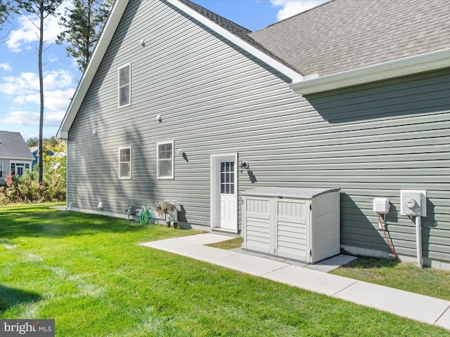 rear view of property featuring a lawn