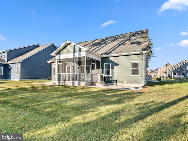 back of house with a yard and a sunroom