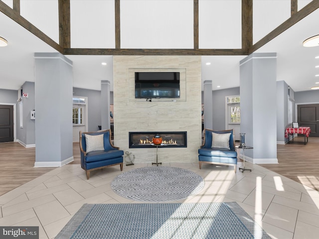 interior space with a tile fireplace and light hardwood / wood-style floors