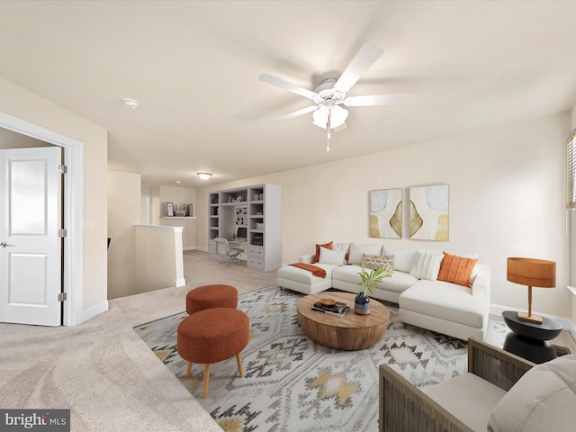 living room with light colored carpet and ceiling fan