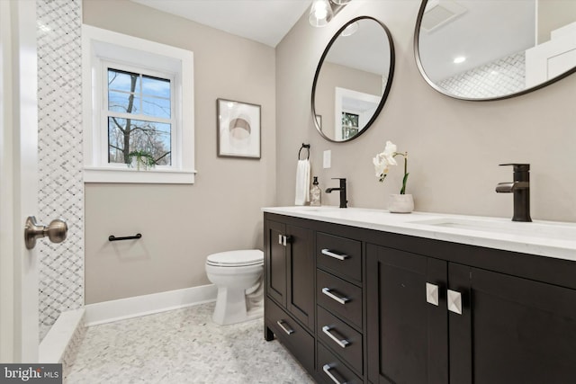 bathroom featuring vanity and toilet