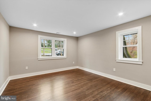 empty room with dark hardwood / wood-style floors