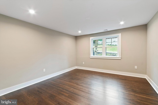 empty room featuring dark wood-type flooring