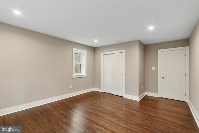 unfurnished bedroom with dark hardwood / wood-style floors