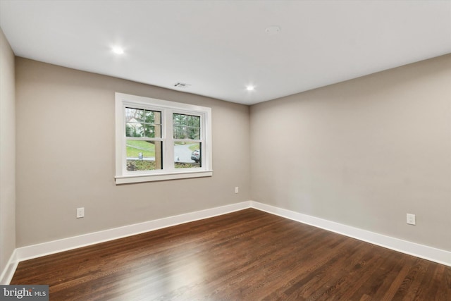 empty room with dark wood-type flooring