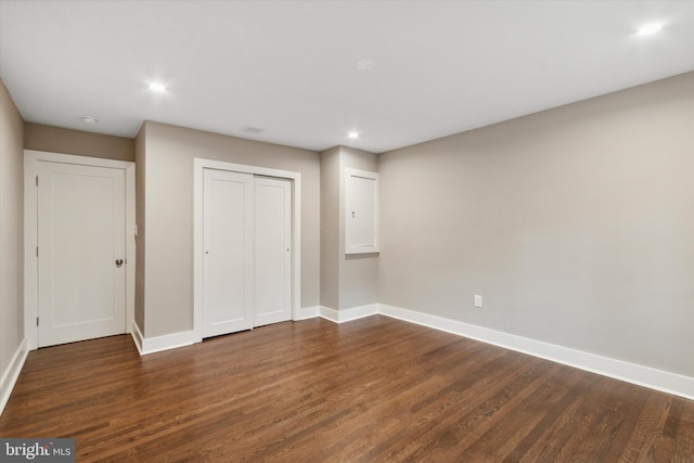 unfurnished bedroom featuring dark hardwood / wood-style floors