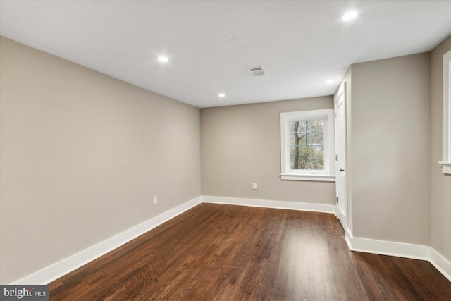 unfurnished room with dark hardwood / wood-style floors