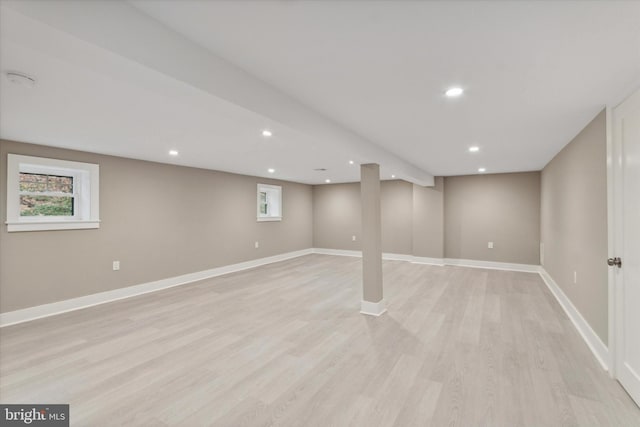 basement with light hardwood / wood-style flooring