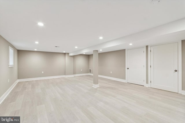 basement with light hardwood / wood-style floors