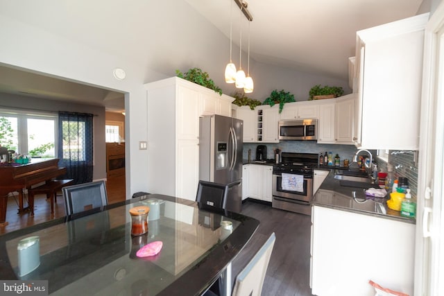 4504 Harbor Beach Blvd, Brigantine, NJ 08203 - kitchen featuring appliances with stainless steel finishes, a sink, backsplash, dark wood-style flooring, and a chandelier