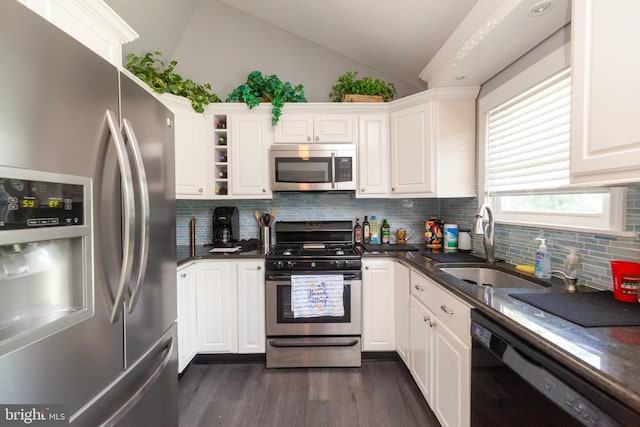 4504 Harbor Beach Blvd, Brigantine, NJ 08203 - kitchen featuring stainless steel appliances, lofted ceiling, a sink, dark countertops, and dark wood finished floors