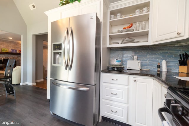 4504 Harbor Beach Blvd, Brigantine, NJ 08203 - kitchen featuring stainless steel fridge with ice dispenser, dark countertops, decorative backsplash, vaulted ceiling, and white cabinetry