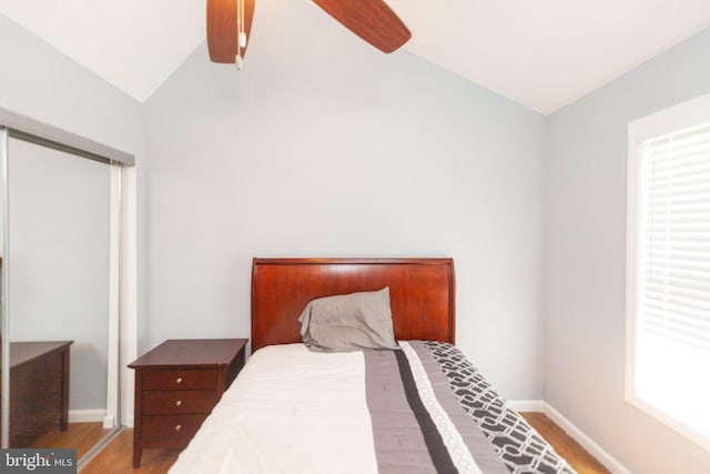 4504 Harbor Beach Blvd, Brigantine, NJ 08203 - bedroom featuring lofted ceiling, wood finished floors, baseboards, multiple windows, and a ceiling fan