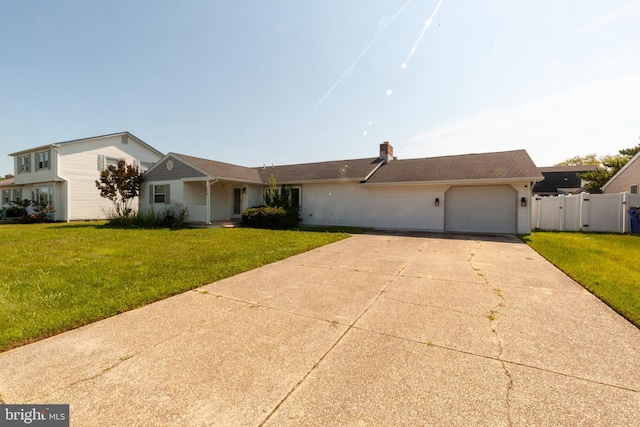 ranch-style home featuring a garage and a front yard