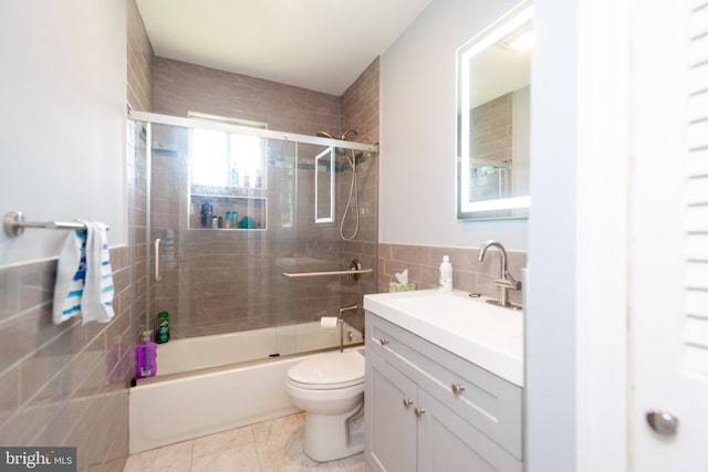 4504 Harbor Beach Blvd, Brigantine, NJ 08203 - full bath featuring tile walls, toilet, vanity, shower / bath combination with glass door, and a wainscoted wall