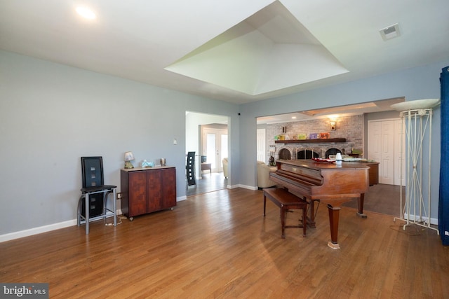 4504 Harbor Beach Blvd, Brigantine, NJ 08203 - sitting room featuring wood finished floors, baseboards, and a brick fireplace