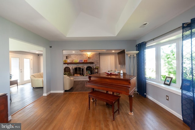 4504 Harbor Beach Blvd, Brigantine, NJ 08203 - living area featuring wood finished floors, baseboards, a brick fireplace, and a raised ceiling