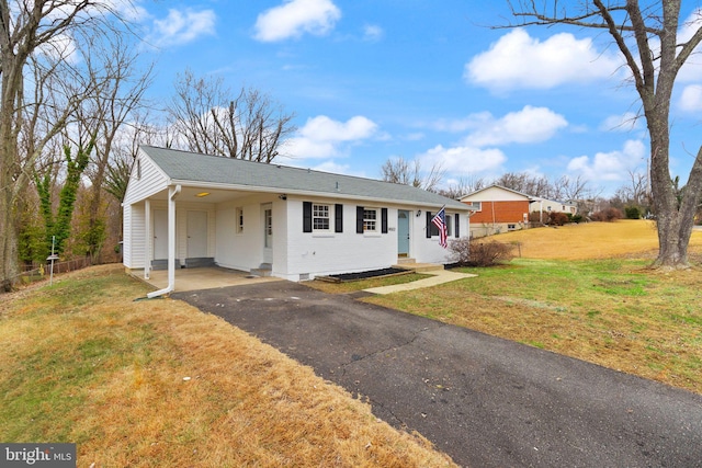 ranch-style home with a front lawn and a carport