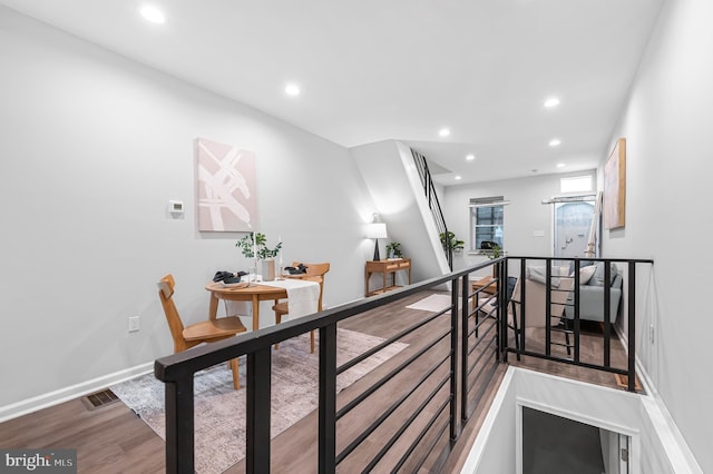 hallway with hardwood / wood-style floors