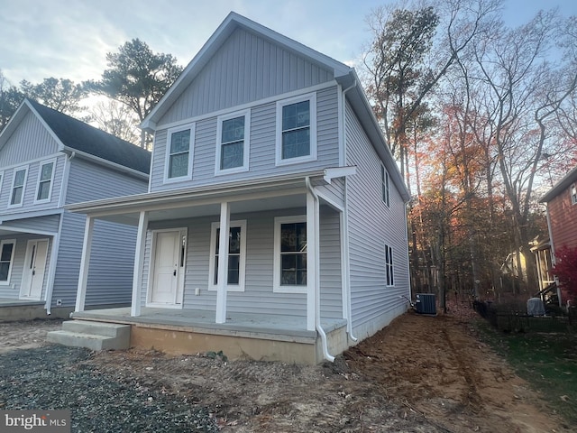 front facade with a porch and central air condition unit