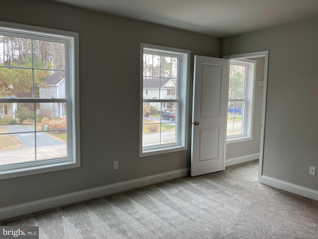 spare room featuring light colored carpet