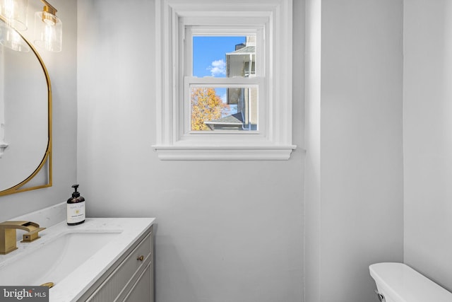 bathroom featuring vanity and toilet