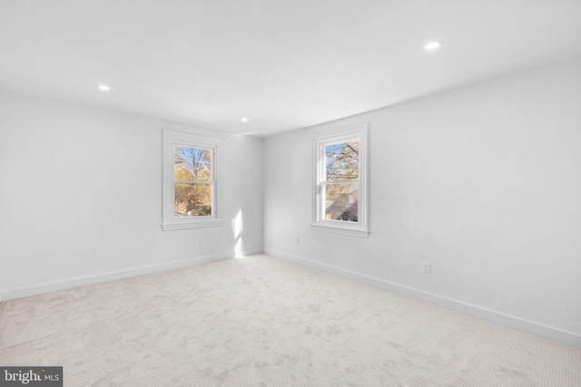 carpeted empty room featuring a wealth of natural light