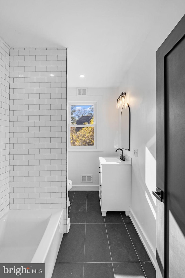 bathroom with tile patterned floors, vanity, and toilet