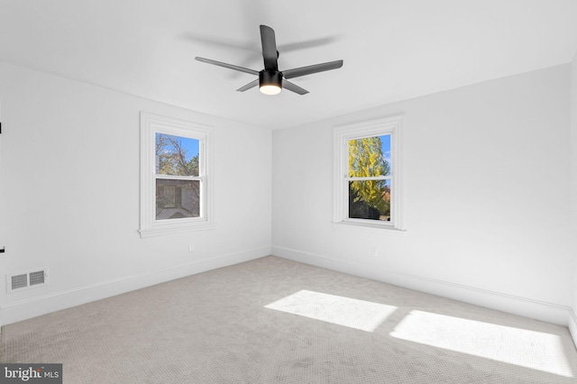 unfurnished room featuring ceiling fan and light carpet