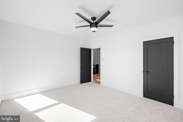 unfurnished bedroom with light carpet and ceiling fan