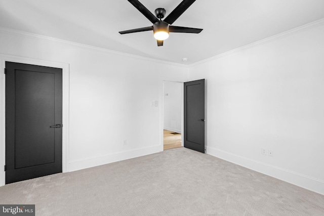 unfurnished bedroom with light carpet, ceiling fan, and crown molding