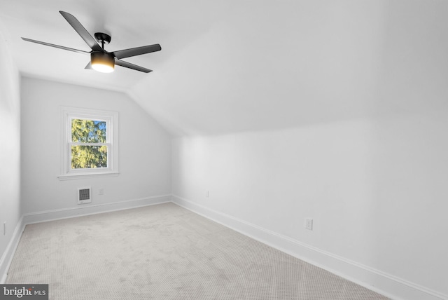 additional living space featuring light carpet, vaulted ceiling, and ceiling fan