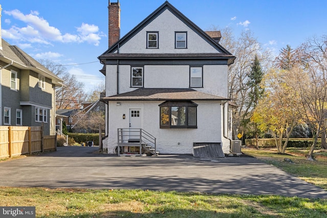 back of property featuring central AC unit