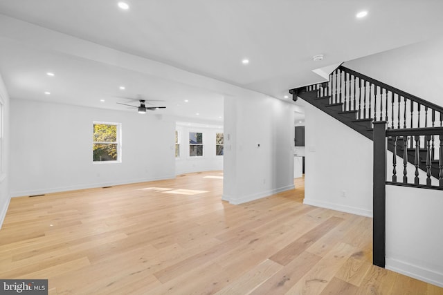 unfurnished living room with light hardwood / wood-style flooring and ceiling fan